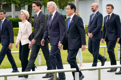 President Joe Biden walks alongside British Prime Minister Rishi Sunak, European Commission President Ursula von der Leyen, Canadian Prime Minister Justin Trudeau, Japan's Prime Minister Fumio Kishida, Italian Premier Giorgia Meloni, European Council President Charles Michel, French President Emmanuel Macron and German Chancellor Olaf Scholz to a flower wreath laying ceremony at the Hiroshima Peace Memorial Park in Japan on Friday. Susan Walsh/Pool/AP
