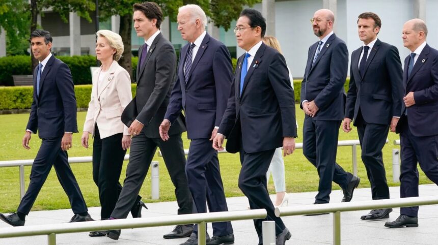 President Joe Biden walks alongside British Prime Minister Rishi Sunak, European Commission President Ursula von der Leyen, Canadian Prime Minister Justin Trudeau, Japan's Prime Minister Fumio Kishida, Italian Premier Giorgia Meloni, European Council President Charles Michel, French President Emmanuel Macron and German Chancellor Olaf Scholz to a flower wreath laying ceremony at the Hiroshima Peace Memorial Park in Japan on Friday. Susan Walsh/Pool/AP