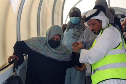 A woman evacuated from Sudan to escape the conflicts is assisted as she arrives in Abu Dhabi airport, United Arab Emirates, April 29, 2023. REUTERS/Rula Rouhana
