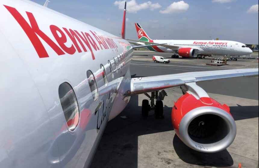 A fleet of Kenya Airways aircraft lined up for takeoff.