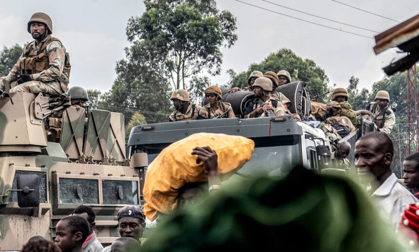 Soldiers from the SADC Mission in the DRC drive past locals fleeing a resumption of fighting, East of Goma, North Kivu, Democratic Republic of Congo. 7 February 2024. (Photo: EPA-EFE / Moses Kasereka)