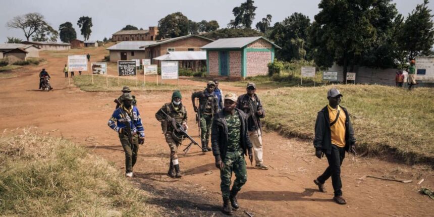 Commanders of the armed group CODECO in the village of Linga, DRC, on January 13, 2022. ALEXIS HUGUET / AFP