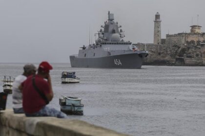 People watch the Russian Navy Admiral Gorshkov frigate arrive at the port of Havana, Cuba, Wednesday, June 12, 2024. A fleet of Russian warships reached Cuban waters on Wednesday ahead of planned military exercises in the Caribbean. (AP Photo/Ariel Ley)