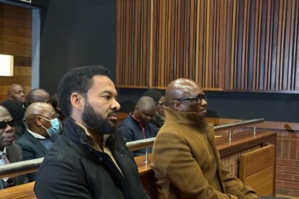 Sports, Arts and Culture minister Zizi Kodwa and his co-accused former EOH boss Jehan Mackay in the dock at the specialised commercial crimes court sitting in Palm Ridge.