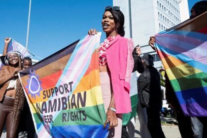 People hold banners in support of LGBTQ rights outside the high court which made a landmark ruling in favour of LGBTQ communities in Windhoek, Namibia, June 21, 2024 REUTERS/Opas Onucheyo