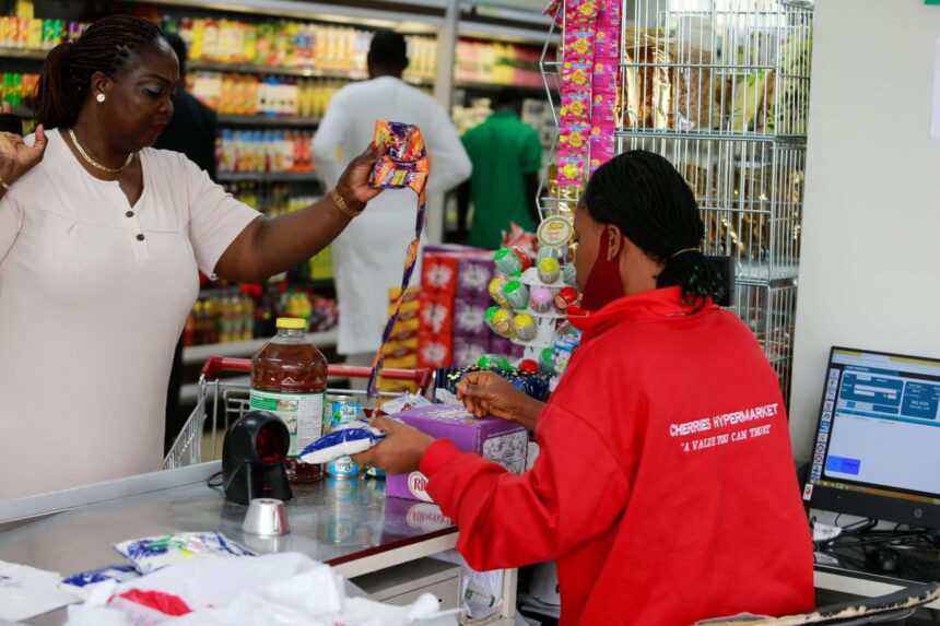 A woman stands at the check out counter after shopping at Cherries Hypermarket in Abuja, Nigeria March 15, 2022. REUTERS/Afolabi Sotunde