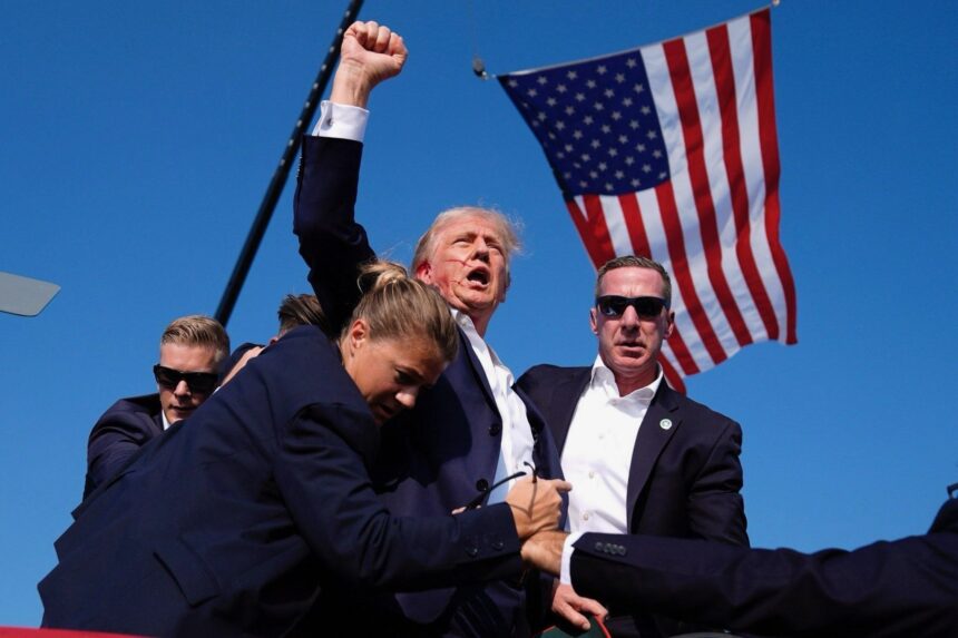 Republican presidential candidate and former U.S. President Donald Trump is assisted by the Secret Service after gunfire rang out during a campaign rally at the Butler Farm Show in Butler, Pennsylvania, U.S., July 13, 2024.. Photo: Evan Vucci/AP