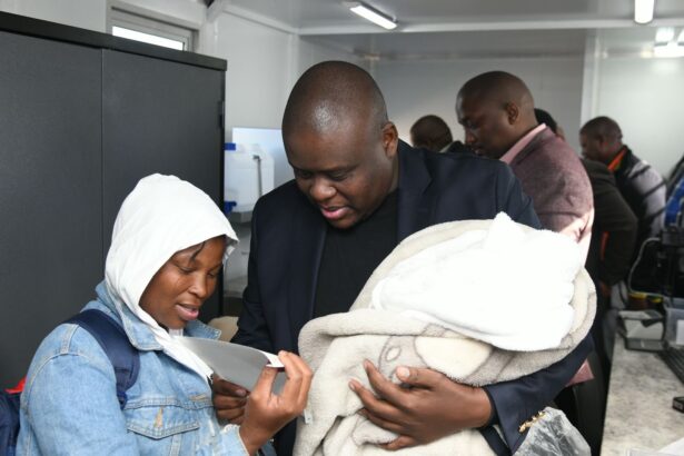 South Africa's Home Affairs Deputy Minister, Mr Njabulo Nzuzahands over a birth certificate to the mother of a two-week-old child inside the mobile office near Gcobani Hall in Buffalo City, South Africa. Photo: X/@HomeAffairsSA