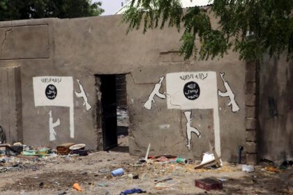 Islamic State flag emblazoned on a wall