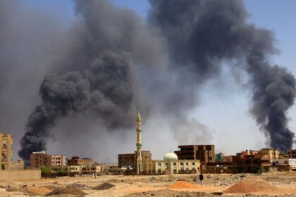 A man walks as smoke rises over buildings following air strikes during clashes between the paramilitary Rapid Support Forces and the Sudanese army in Khartoum North on May 1, 2023. File | Reuters