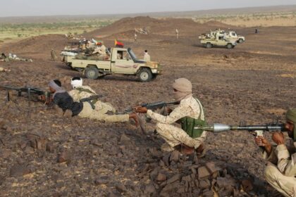 Tuaregs fighters near pick up trucks with machine gun near Kidal, northern Mali on September 28, 2016. [File/AFP]