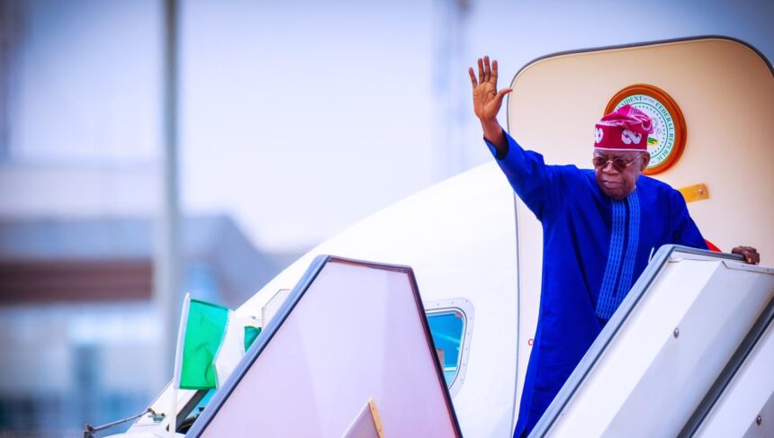 President Bola Tinubu of Nigeria waves from the airplane