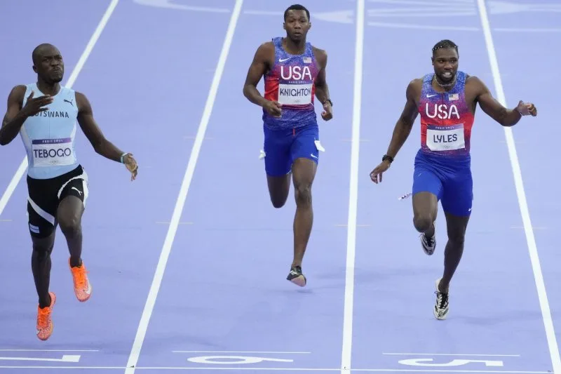 Letsile Tebogo of Botswana (left) and Team USA's Erriyon Knighton (center) and Noah Lyles cross the finish line in the men's 200-meter final at the 2024 Olympics on Thursday at the Stade de France in Paris. Photo by Paul Hanna/UPI.