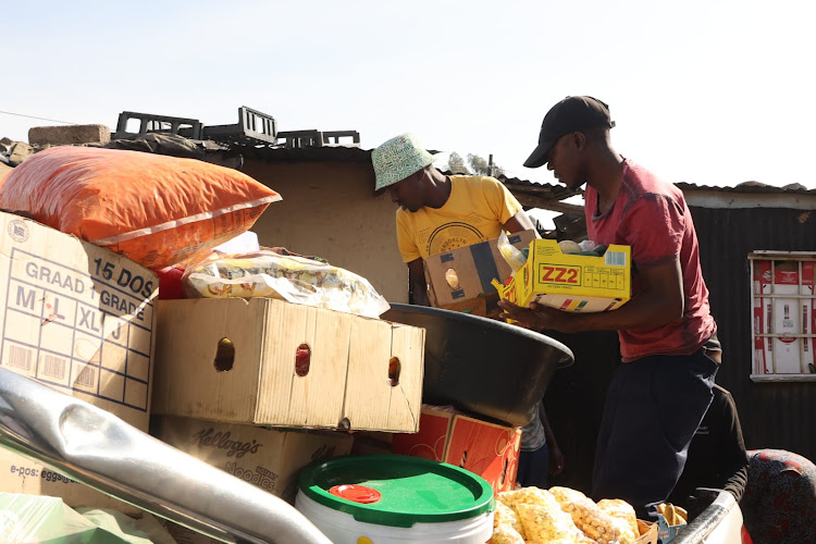 Residents of Soweto, mostly in Operation Dudula regalia are moving around Soweto forcefully closing shops owned by foreigners nationals. Image: Antonio Muchave