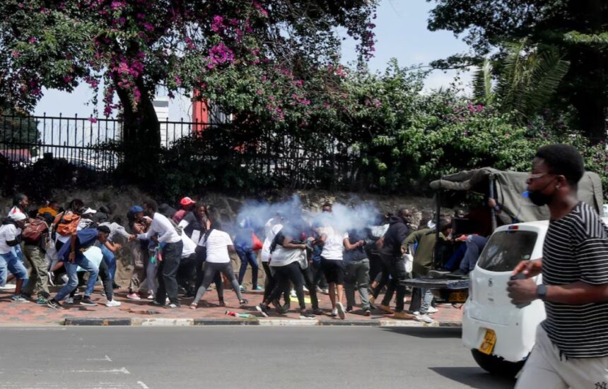 Activists and civil society members react after police officers used teargas to disperse them during a nationwide march titled "End Femicide Kenya" to raise awareness about gender-based violence (GBV) and to pressure the Kenyan government to implement stricter laws and policies to combat this pervasive issue, in downtown Nairobi, Kenya December 10, 2024. REUTERS/Monicah Mwangi
