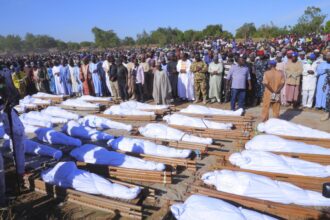 People attend a funeral for those killed by suspected Boko Haram militants in Zaabarmar, Nigeria, on Sunday. (Jossy Ola / AP)