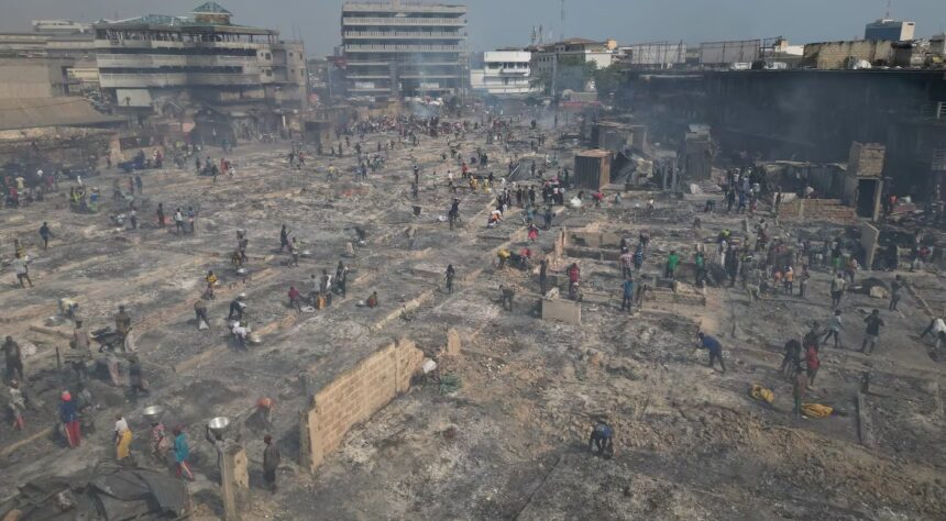 This aerial view shows people trying to salvage items from the burned down secondhand clothing market at Kantamanto in Accra. AFP - NIPAH DENNIS