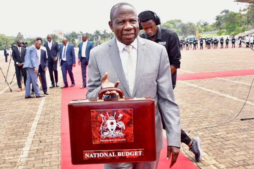 Uganda's Minister of Finance Matia Kasaija displays a briefcase carrying National Budget 2024/25 before presenting it to the nation during a budget speech at Kololo airstrip in Kampala, Uganda, June 13, 2024. REUTERS/Michael Muhati/File Photo